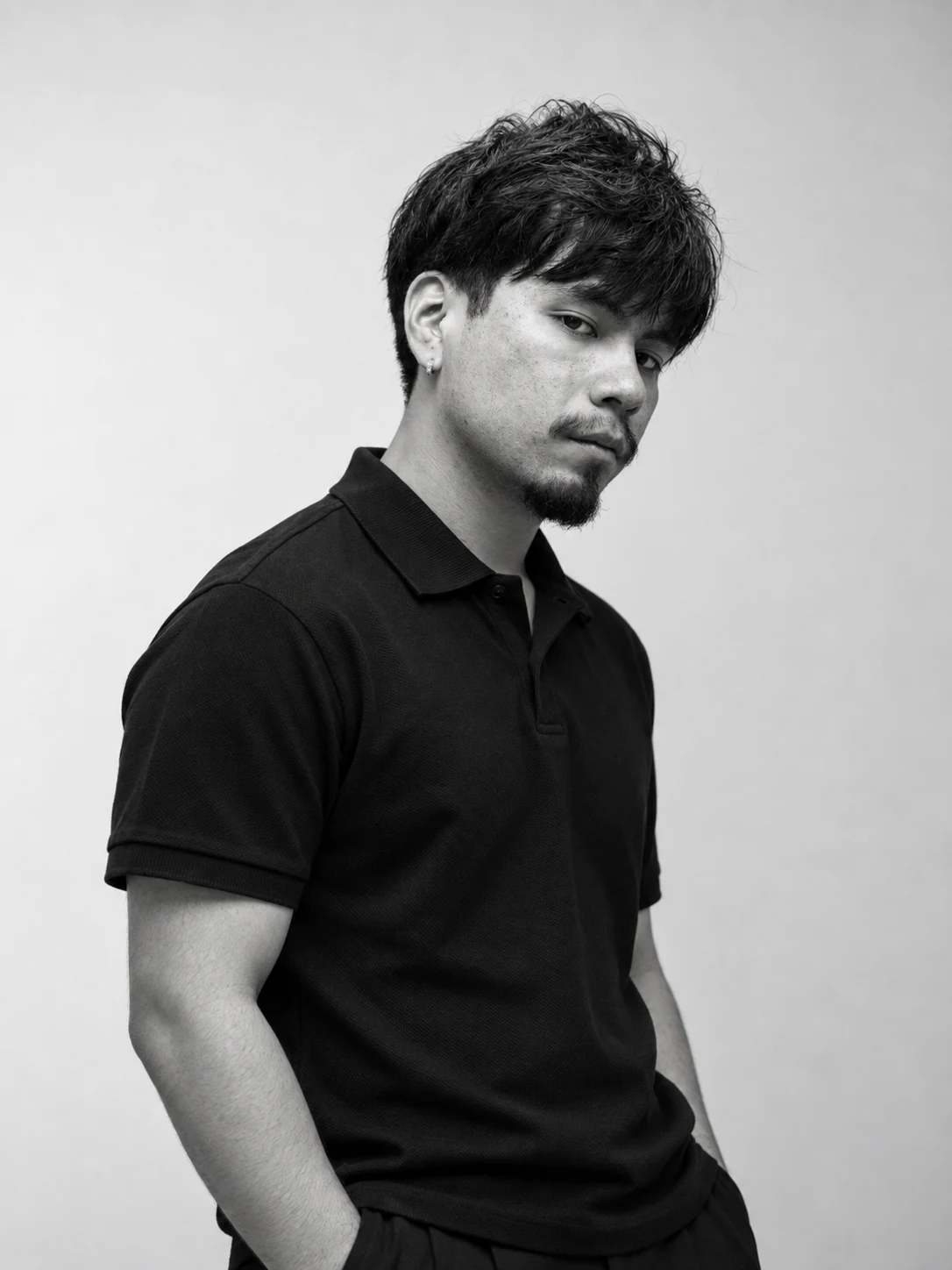 Black-and-white portrait of Alexis Vacio wearing a black polo